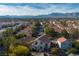 A high aerial of Southwestern style homes in a community with mountain views in the distance at 1100 Meridian Bay Dr, Las Vegas, NV 89128