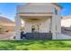 Backyard featuring a covered patio with furniture and artificial grass at 1100 Meridian Bay Dr, Las Vegas, NV 89128