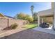 Backyard featuring a covered patio with furniture and artificial grass at 1100 Meridian Bay Dr, Las Vegas, NV 89128