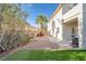 Backyard featuring a patio, artificial grass, and desert landscaping at 1100 Meridian Bay Dr, Las Vegas, NV 89128