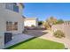 Backyard with patio, small patch of artificial grass, and rock landscaping at 1100 Meridian Bay Dr, Las Vegas, NV 89128