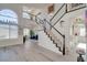 Inviting entryway with staircase, high ceilings, and plenty of natural light from large windows at 1100 Meridian Bay Dr, Las Vegas, NV 89128