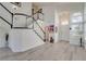 Welcoming entryway featuring staircase, high ceilings, and contemporary decor at 1100 Meridian Bay Dr, Las Vegas, NV 89128