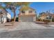 Charming two-story home with a well-maintained front yard and an attached two-car garage at 1100 Meridian Bay Dr, Las Vegas, NV 89128