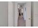 Hallway featuring neutral walls, carpet and view into other rooms at 1100 Meridian Bay Dr, Las Vegas, NV 89128