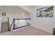 Upstairs landing featuring a black railing and ample natural light at 1100 Meridian Bay Dr, Las Vegas, NV 89128