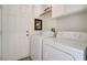 Functional laundry room with washer, dryer, and overhead storage at 1100 Meridian Bay Dr, Las Vegas, NV 89128