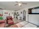 Open-concept living room featuring updated kitchen, white cabinets, and hardwood floors at 1100 Meridian Bay Dr, Las Vegas, NV 89128