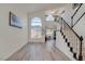 Bright living room with staircase, soaring ceilings, and expansive windows allowing natural light at 1100 Meridian Bay Dr, Las Vegas, NV 89128