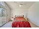 Bright, spacious main bedroom featuring neutral walls, carpet, ceiling fan and sliding glass doors to a private balcony at 1100 Meridian Bay Dr, Las Vegas, NV 89128