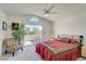 Bright, spacious main bedroom featuring neutral walls, carpet, ceiling fan and sliding glass doors to a private balcony at 1100 Meridian Bay Dr, Las Vegas, NV 89128