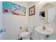 Charming powder room featuring a pedestal sink and unique wall art at 1100 Meridian Bay Dr, Las Vegas, NV 89128