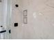 Modern shower featuring black hardware and marble walls at 1100 Meridian Bay Dr, Las Vegas, NV 89128