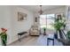 Cozy sitting room with comfortable armchair, piano, and large window providing natural light at 1100 Meridian Bay Dr, Las Vegas, NV 89128
