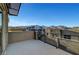 Balcony with a modern railing offers picturesque views of mountains, nearby houses, and open sky at 11297 Essence Point Ave # 102, Las Vegas, NV 89135