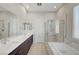 This bathroom features marble countertops, double sinks, a soaking tub, and a shower at 11297 Essence Point Ave # 102, Las Vegas, NV 89135