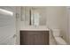 This bathroom features a mirror, single sink, and toilet with hard surface floors at 11297 Essence Point Ave # 102, Las Vegas, NV 89135