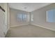 This is a carpeted bedroom with three windows and hard wired for a TV at 11297 Essence Point Ave # 102, Las Vegas, NV 89135