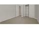 This carpeted bedroom features a walk-in closet and a doorway that leads to another room at 11297 Essence Point Ave # 102, Las Vegas, NV 89135