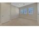 Bright bedroom with tile flooring, multiple windows, and a closet at 11297 Essence Point Ave # 102, Las Vegas, NV 89135