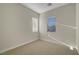 This bedroom features neutral walls, carpet, and two windows to let the light into the home at 11297 Essence Point Ave # 102, Las Vegas, NV 89135