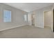 This carpeted bedroom includes a walk-in closet and two windows that face the exterior at 11297 Essence Point Ave # 102, Las Vegas, NV 89135