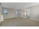 Expansive carpeted bonus room with abundant natural light and recessed lighting presents a versatile living space at 11297 Essence Point Ave # 102, Las Vegas, NV 89135
