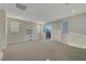 Bright bonus room with plush carpeting, recessed lighting, and a sliding door to a balcony with city views at 11297 Essence Point Ave # 102, Las Vegas, NV 89135
