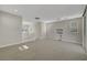 Spacious bonus room featuring neutral carpeting, modern railings, and a sliding glass door for seamless indoor-outdoor living at 11297 Essence Point Ave # 102, Las Vegas, NV 89135
