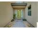 Welcoming front entrance featuring a modern green door, desert landscaping, and a paved walkway at 11297 Essence Point Ave # 102, Las Vegas, NV 89135