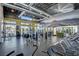 Modern gym with a variety of equipment, including treadmills and weight machines, with an adjacent fitness studio at 11297 Essence Point Ave # 102, Las Vegas, NV 89135