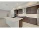 Kitchen features a center island, modern appliances, and sleek countertops at 11297 Essence Point Ave # 102, Las Vegas, NV 89135