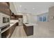 Modern kitchen with a large island, stainless steel appliances, and tile floors at 11297 Essence Point Ave # 102, Las Vegas, NV 89135