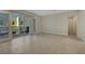 Bright, empty living room with tile floors, a sliding glass door to the balcony, and neutral paint at 11297 Essence Point Ave # 102, Las Vegas, NV 89135