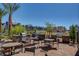 Community outdoor grill space for residents to enjoy with tables, chairs, shade and barbecue area at 11297 Essence Point Ave # 102, Las Vegas, NV 89135