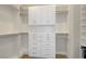 This is a walk-in closet with multiple shelves, drawers, and cabinets at 11297 Essence Point Ave # 102, Las Vegas, NV 89135