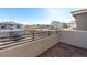 Private balcony with railing offering panoramic views of the community and the street at 11756 Emerald Lake Ave, Las Vegas, NV 89138