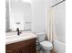 A bathroom features wood look flooring, a single vanity, and shower-tub combo at 11756 Emerald Lake Ave, Las Vegas, NV 89138