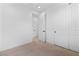 Clean bedroom with plush carpeting and minimalist design featuring white doors at 11756 Emerald Lake Ave, Las Vegas, NV 89138