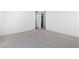 Neutral bedroom with plush carpeting and a view into the closet space at 11756 Emerald Lake Ave, Las Vegas, NV 89138
