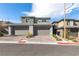 Modern townhome exterior showcasing a multi-car garage and manicured landscaping at 11756 Emerald Lake Ave, Las Vegas, NV 89138