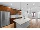 Modern kitchen features stainless steel appliances, white countertops, wood floors and stylish pendant lighting at 11756 Emerald Lake Ave, Las Vegas, NV 89138