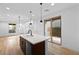 Bright, modern kitchen with white countertops, dark cabinets, stainless steel appliances and wood floors at 11756 Emerald Lake Ave, Las Vegas, NV 89138