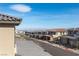 Charming neighborhood street featuring modern homes and a panoramic city view in the distance at 11756 Emerald Lake Ave, Las Vegas, NV 89138