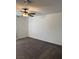 Carpeted bedroom featuring a ceiling fan, neutral walls and a large window at 1197 Mission View Ct, Henderson, NV 89002