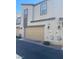 Two story exterior elevation of a multi-Gathering home with tan colored garage doors and trimmed windows at 1197 Mission View Ct, Henderson, NV 89002