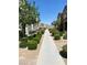 Charming exterior view with landscaped walkway leading to townhomes and mature trees at 1197 Mission View Ct, Henderson, NV 89002