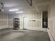 Spacious two car garage with smooth concrete flooring, overhead lighting, and shelving installed at 1197 Mission View Ct, Henderson, NV 89002