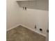 Compact laundry room with tile flooring, shelving, and washer/dryer hookups at 1197 Mission View Ct, Henderson, NV 89002