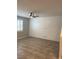 Bright living room featuring tile flooring, plantation shutters, and a modern ceiling fan at 1197 Mission View Ct, Henderson, NV 89002